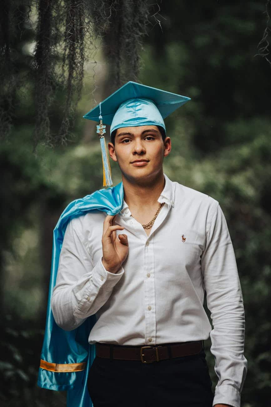 portrait of man in white shirt and academic hat